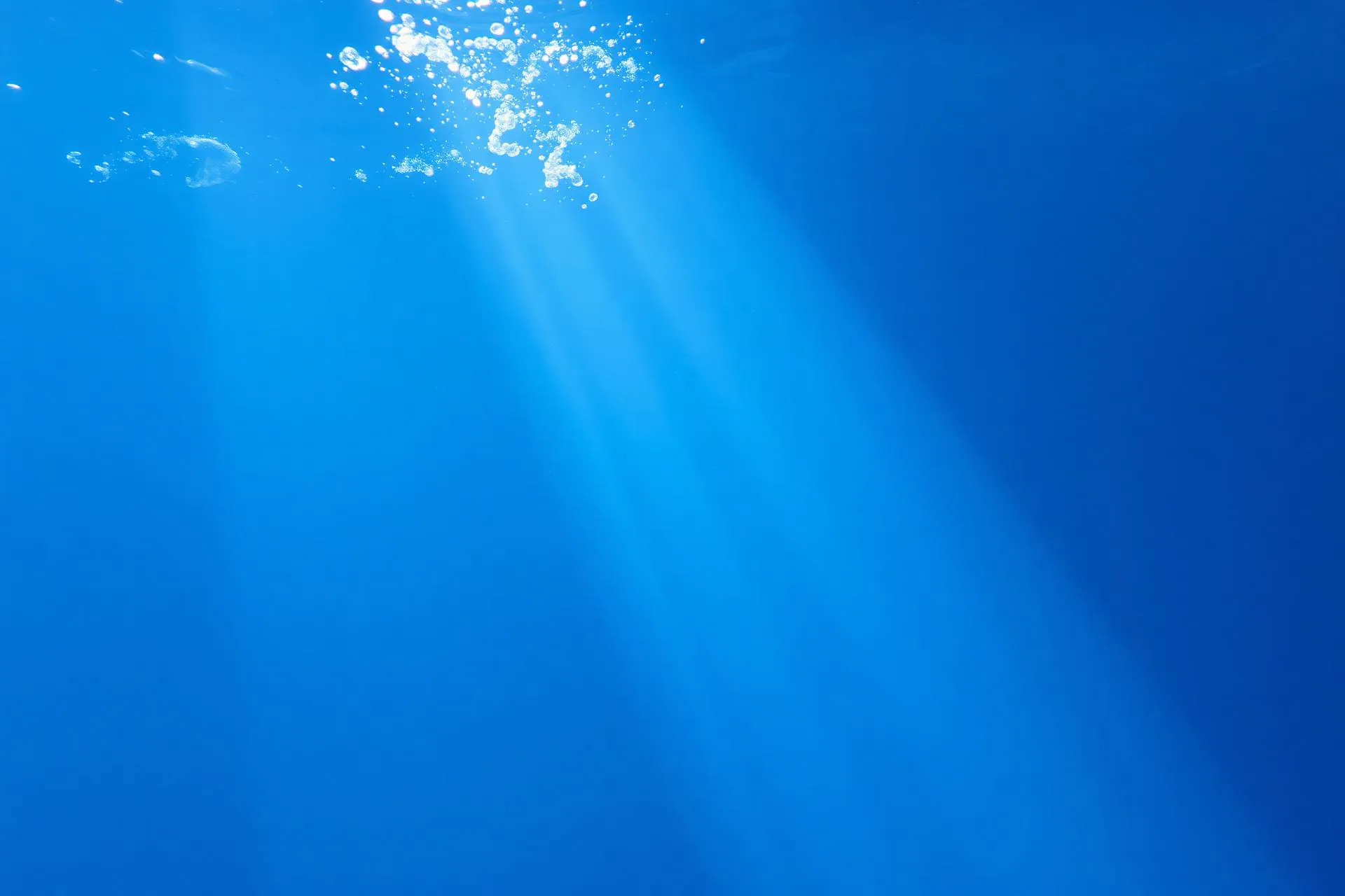 Sunlight streaming through underwater aquarium blue